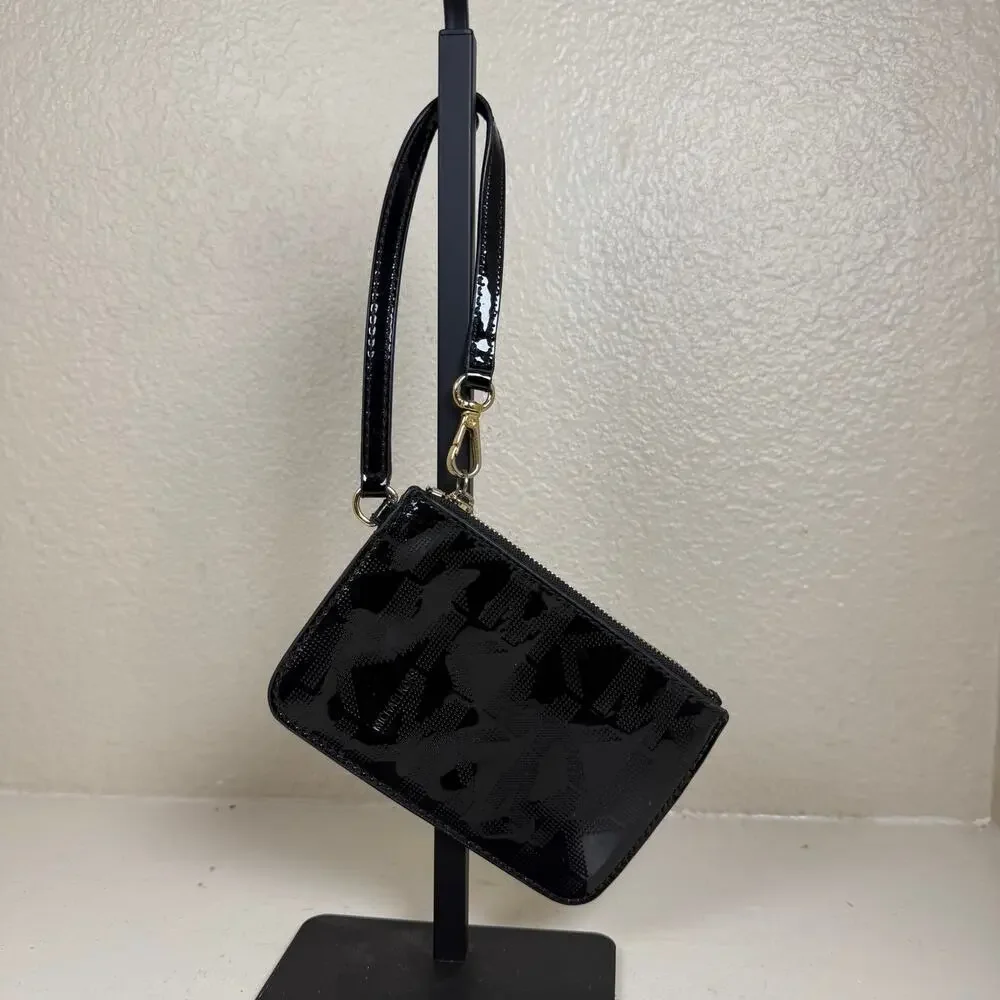 Michael Kors black patent leather wristlet featuring iconic MK monogram pattern